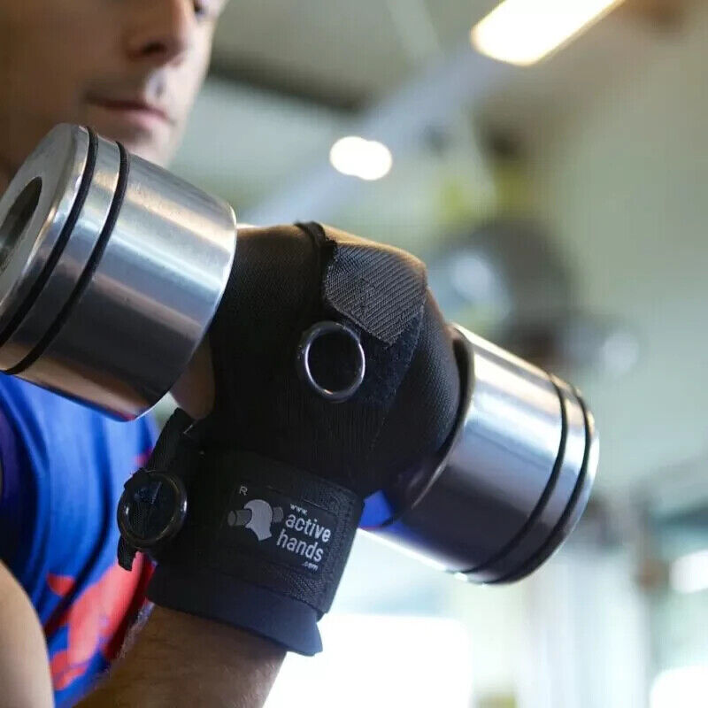 young bald guy in a blue tanktop holds a dumbell with a gripping aid glove