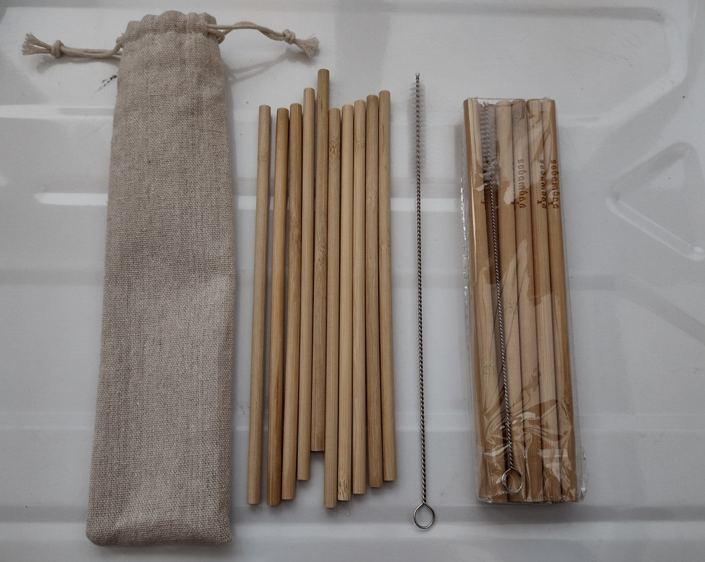 cloth bag and bamboo straws and a cleaning brush