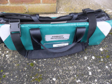 green padded bag with 'Primary Response' Lable